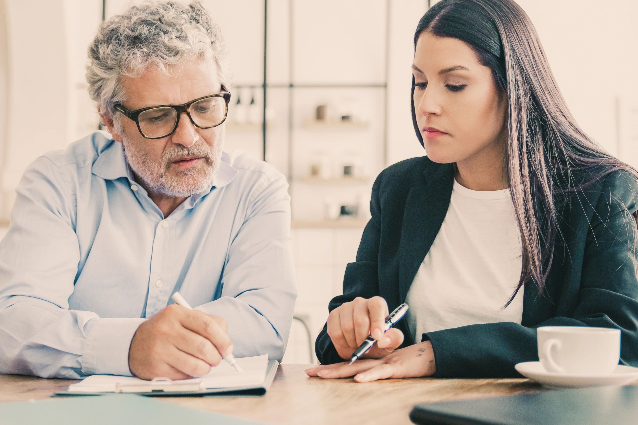 Accountant consulting with a client over financial documents